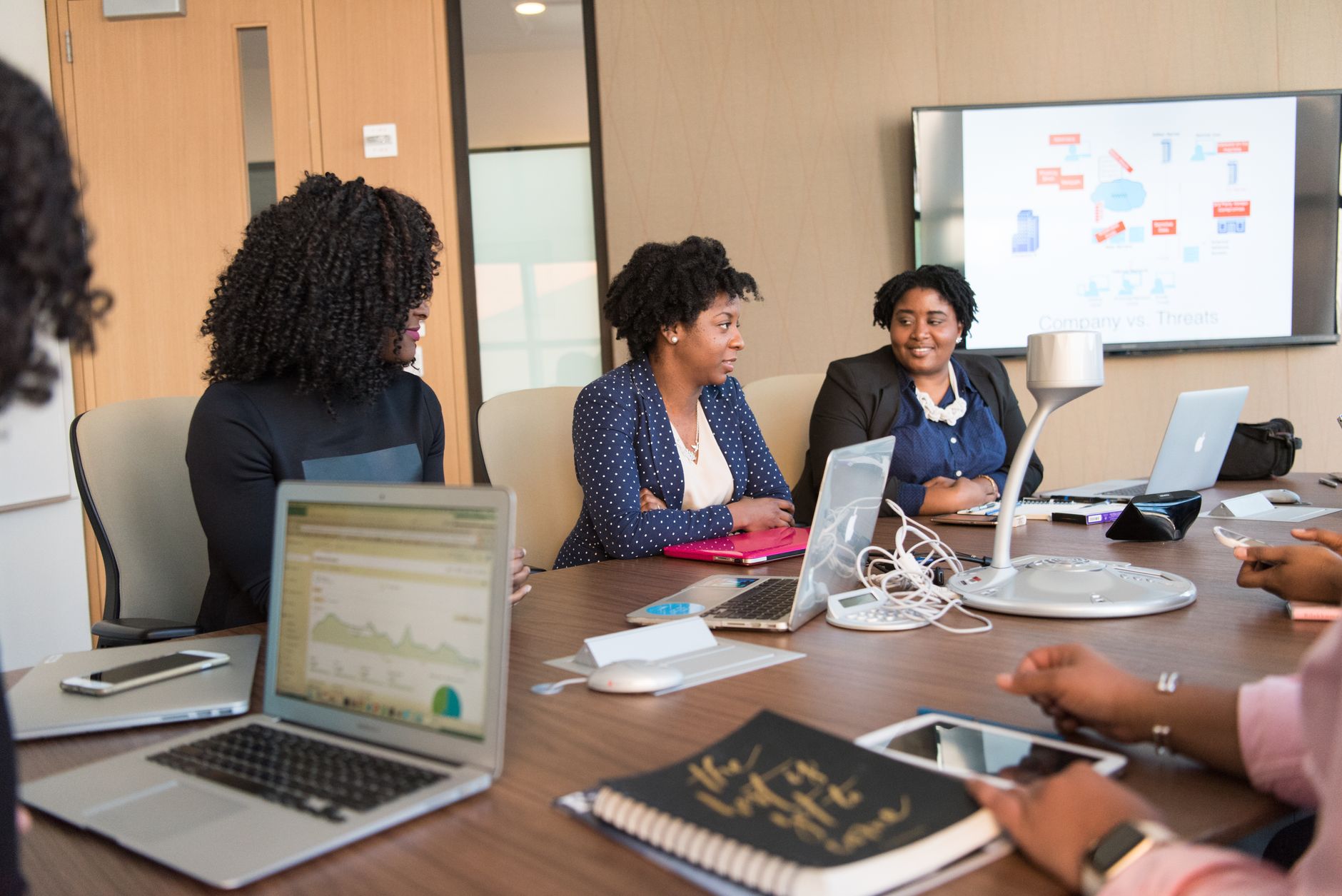 Business professionals reviewing software dashboards in a conference room