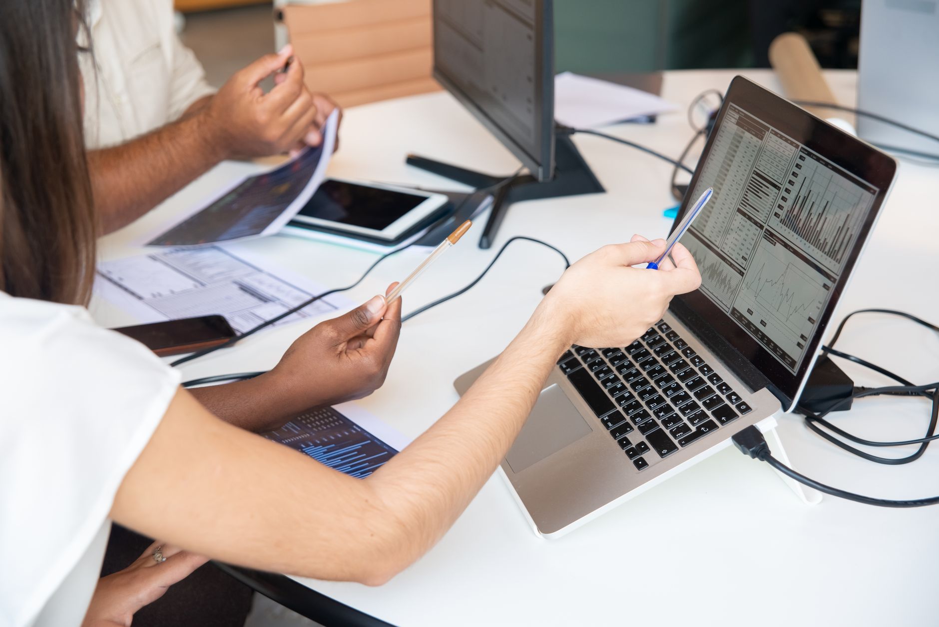 Business professionals reviewing AI software on laptops during an enterprise technology meeting