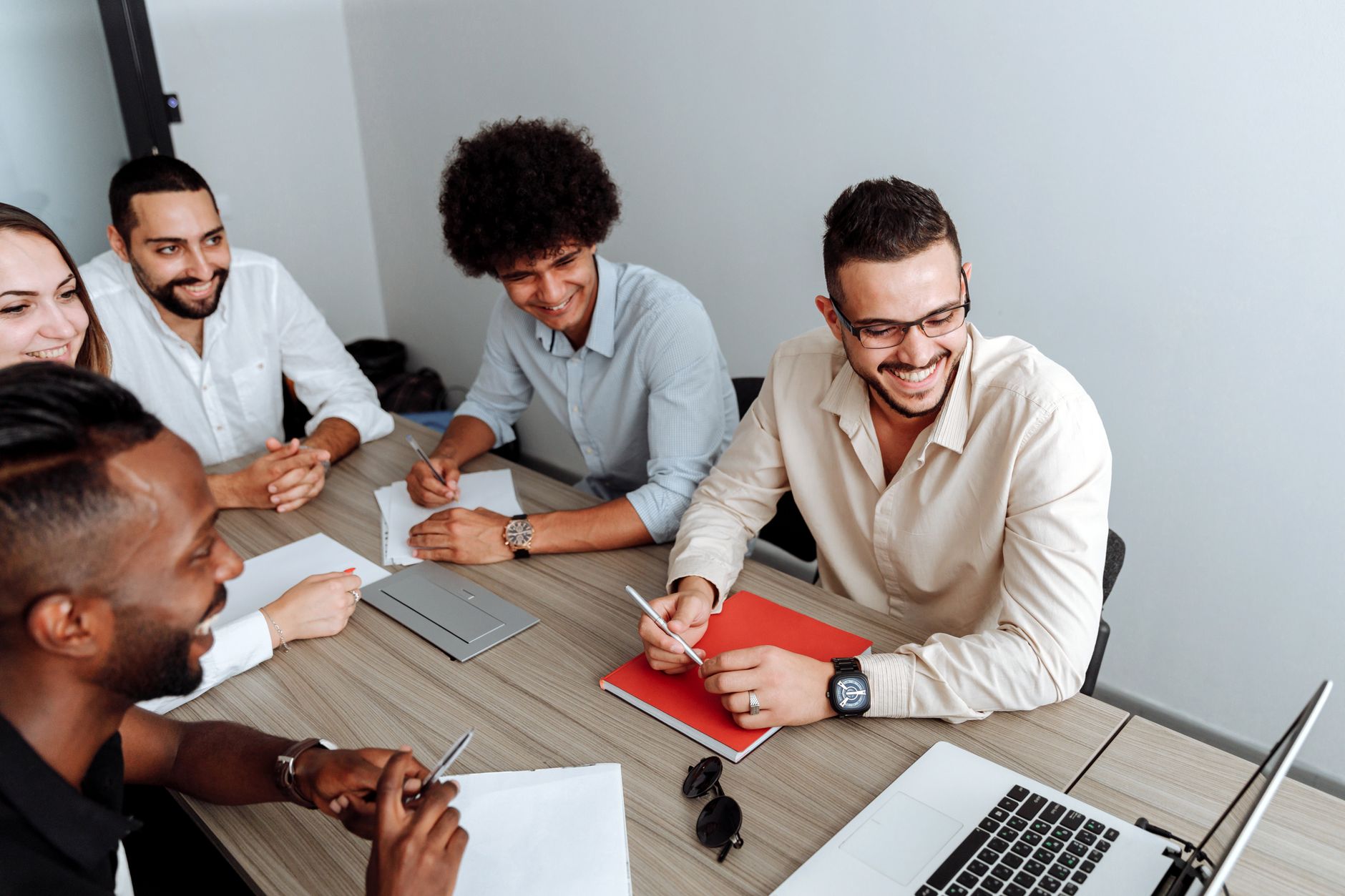 A small team gathered around a table reviewing documents in a startup office