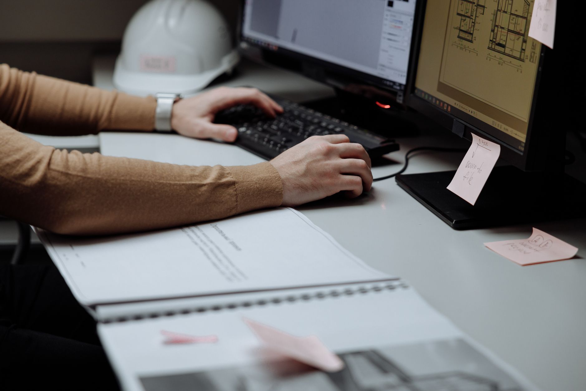 Person reviewing technical documentation on a computer monitor