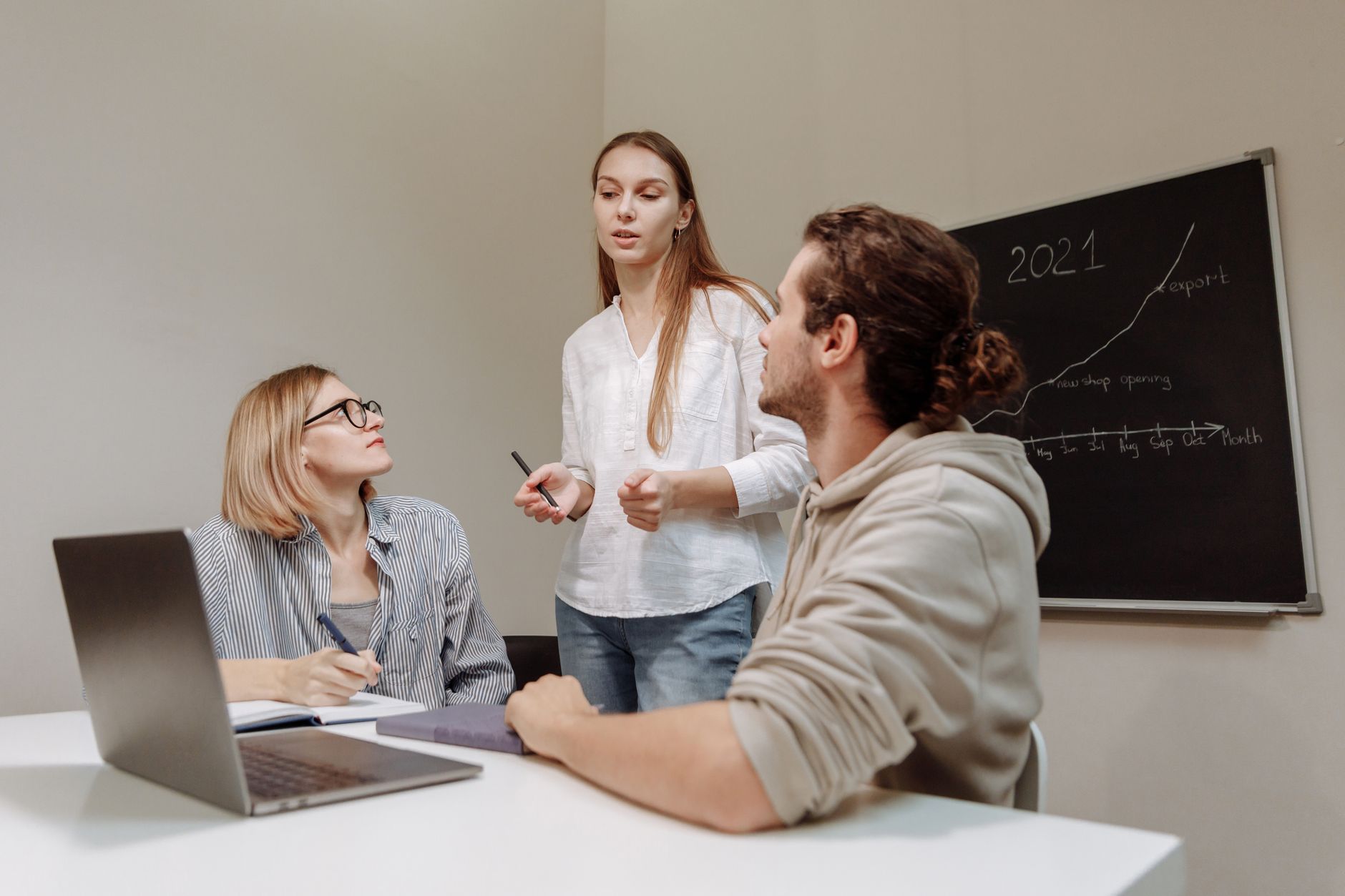 Small team gathered around a table in discussion during a business meeting
