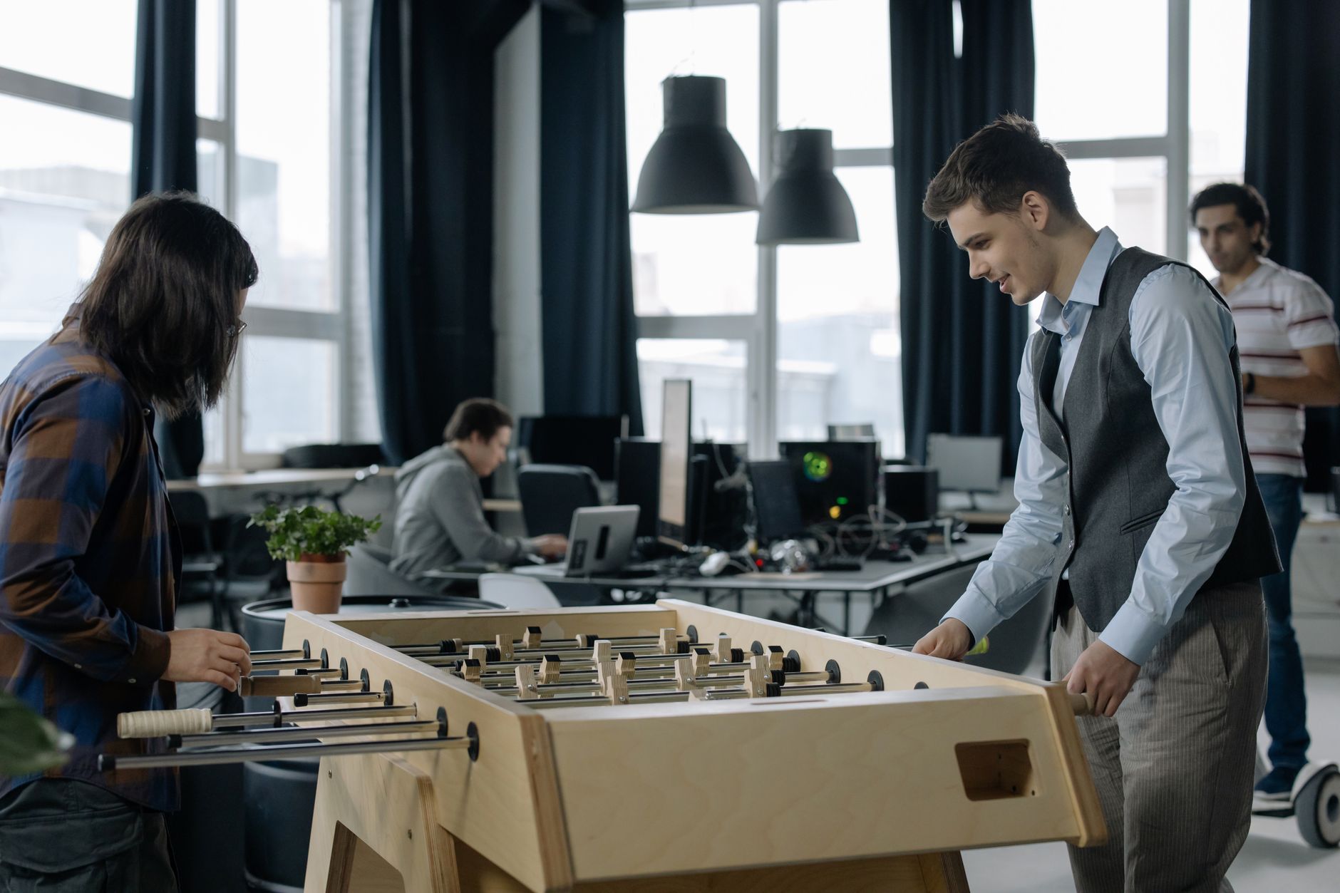 Open-plan startup office with employees working at modern desks