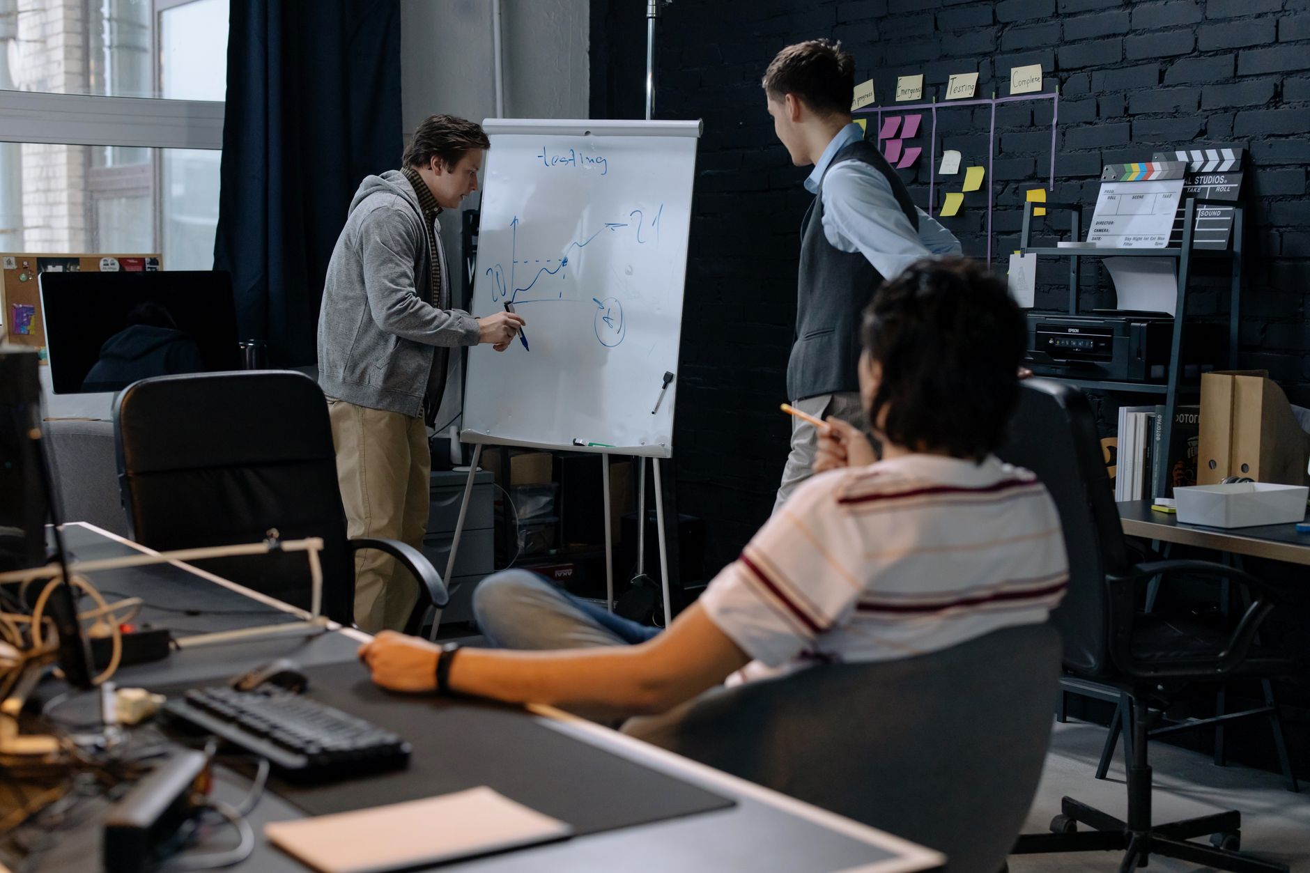 Small tech team reviewing software architecture in a startup office setting