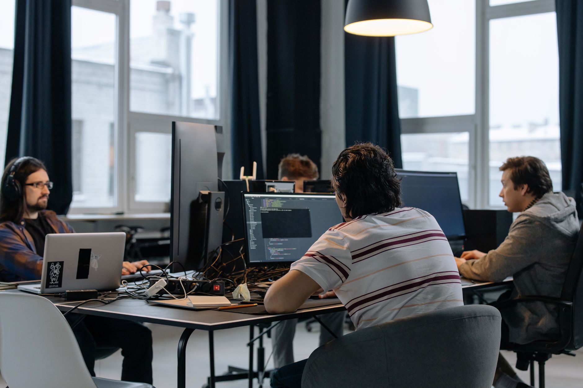 A small tech startup team collaborating around computers in an open office