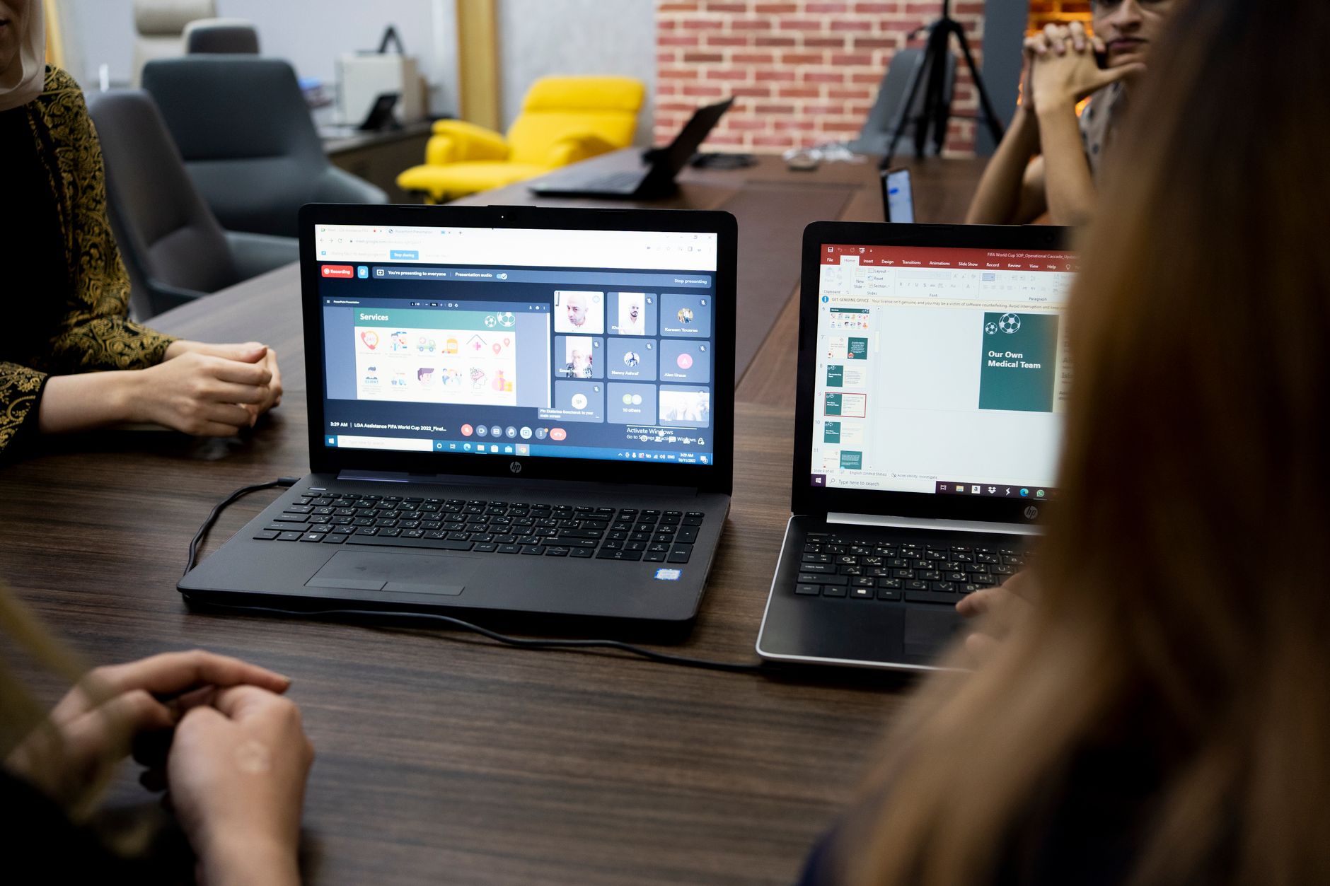 Team members reviewing video content together on a large monitor in a modern office