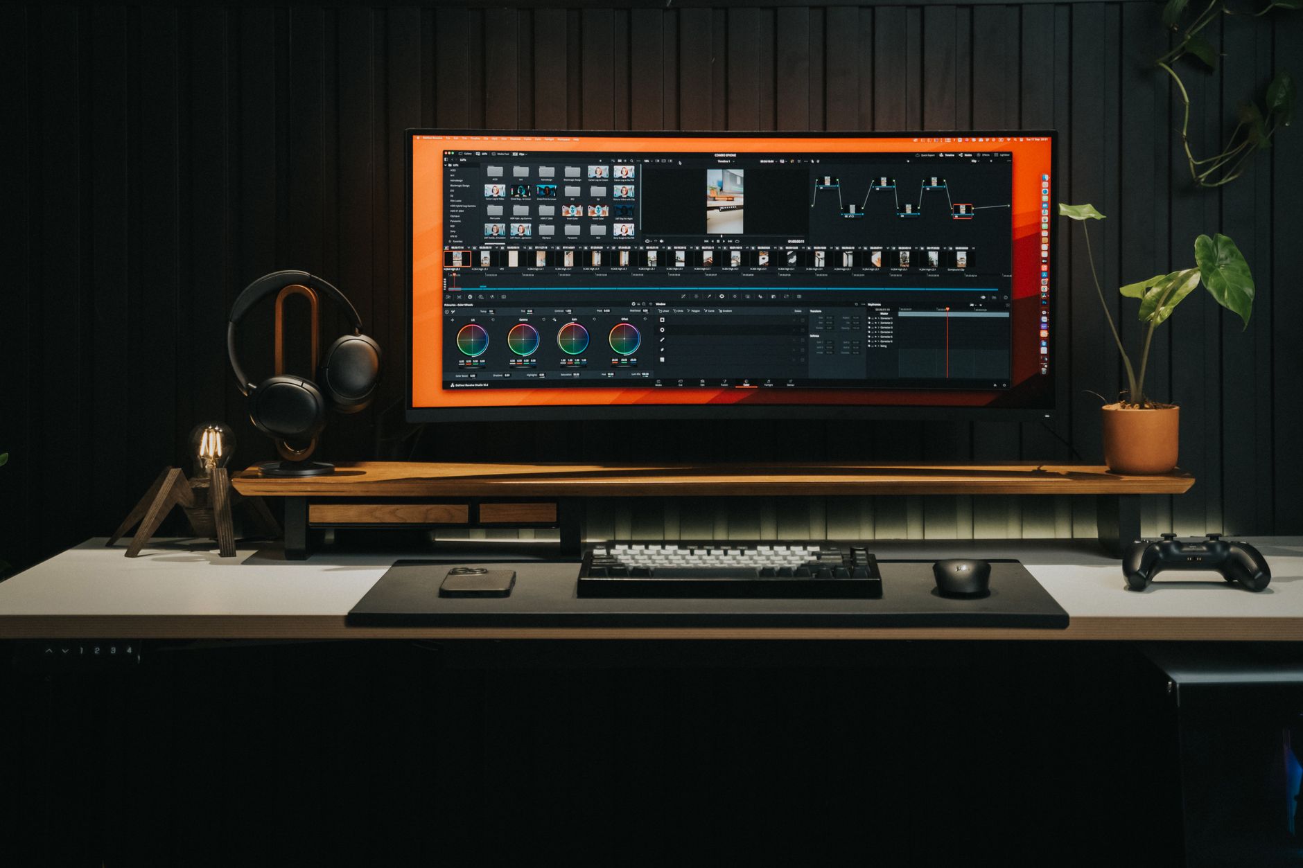 A professional video editing workstation with multiple monitors showing timeline software