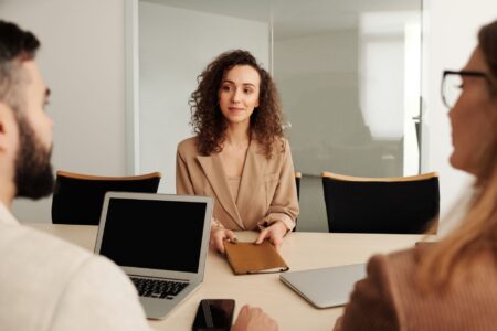 Ashby’s Recruiting Platform Is Quietly Cornering Greenhouse’s Mid-Market Base Two people in a professional office setting conducting a job interview across a desk