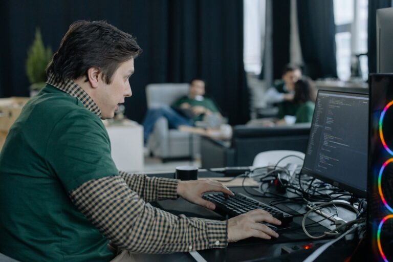 Linear’s Project Tracking Layer Is Quietly Cornering Jira’s Dev Base Software developers collaborating around monitors in a modern open office