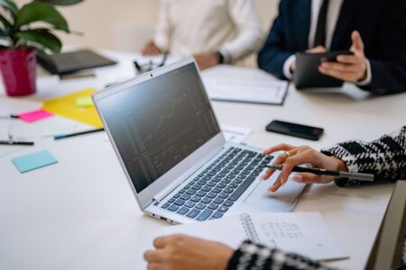 Granola’s AI Notepad Is Quietly Cornering Notion’s Meeting Base Person typing notes on a laptop during a video call meeting