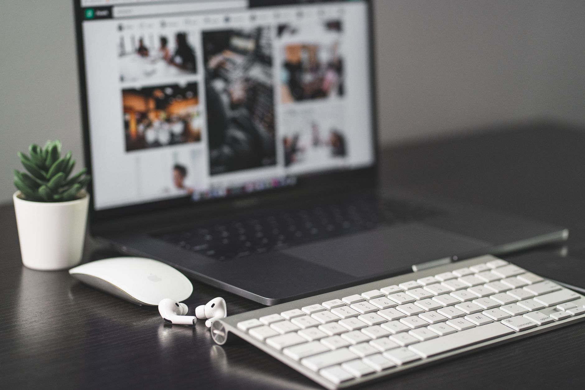 A clean modern desk workspace with laptop and notebook representing digital productivity tools