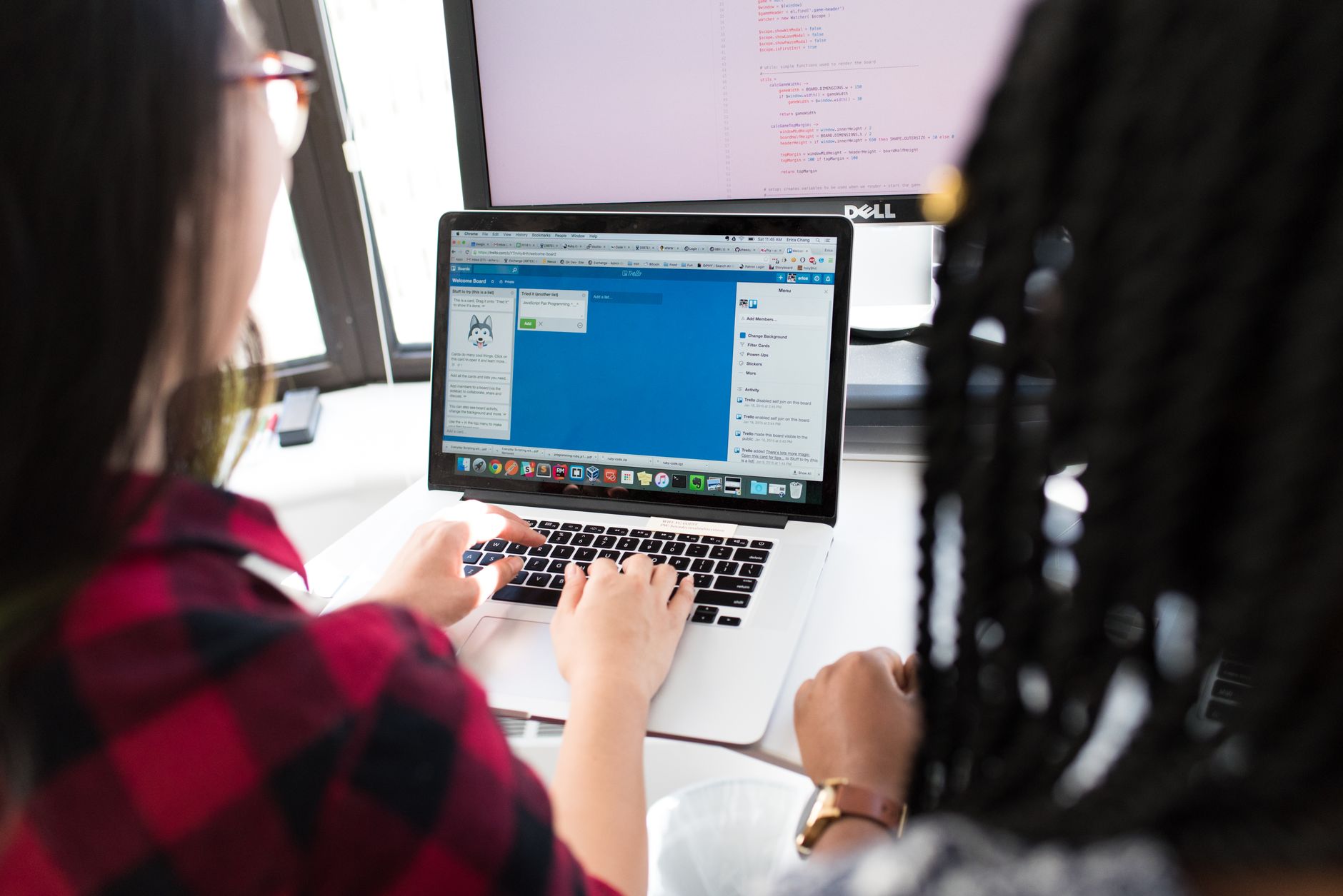 Two developers working together on a shared screen building a web application