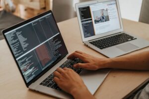 Windsurf’s AI Code Editor Is Quietly Peeling Away Cursor’s Enterprise Base A developer working on code at a laptop, representing AI-assisted software development tools