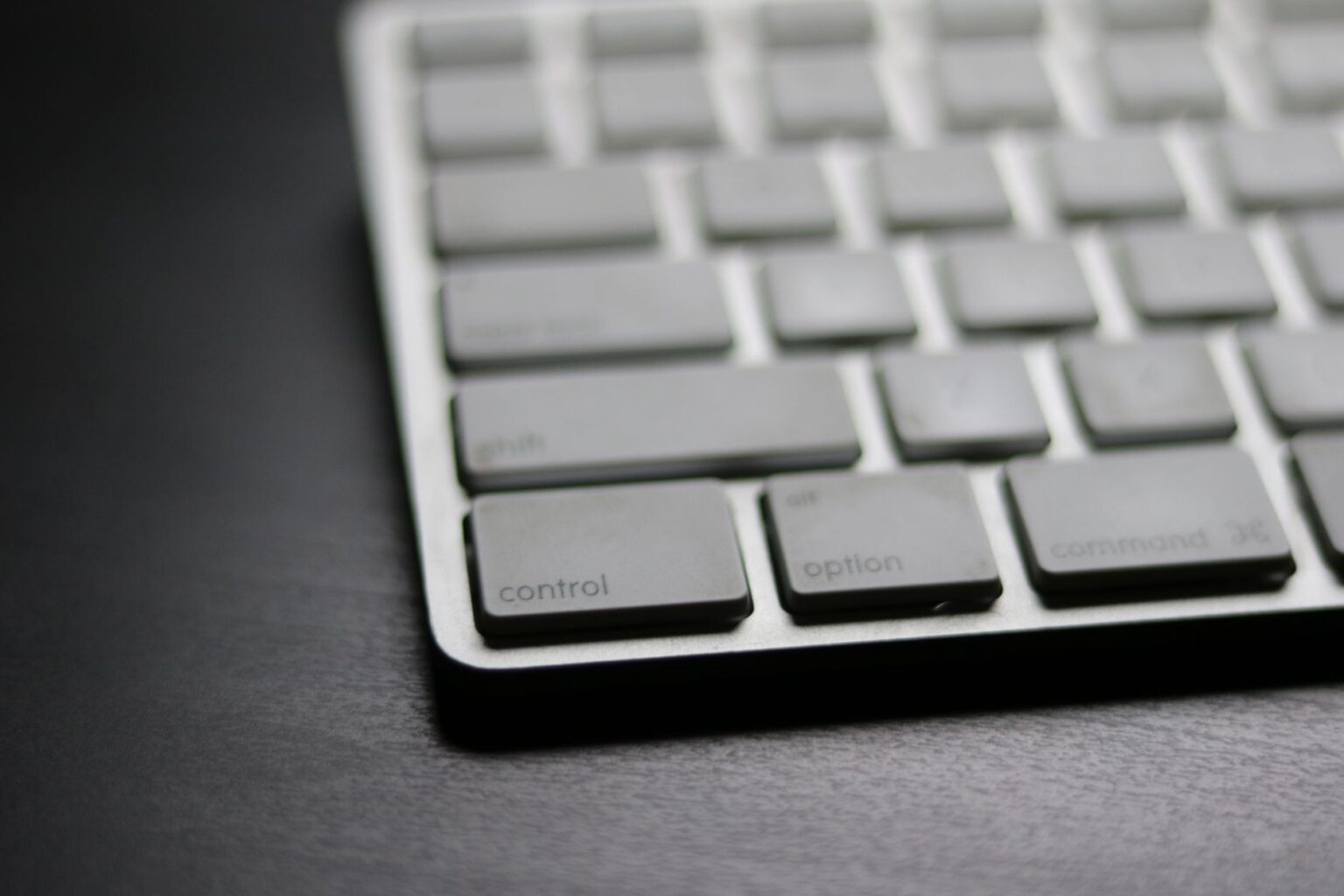 Raycast’s Productivity Layer Is Quietly Cornering Notion’s Power User Base A clean Mac desk setup with keyboard, representing keyboard-driven productivity tools