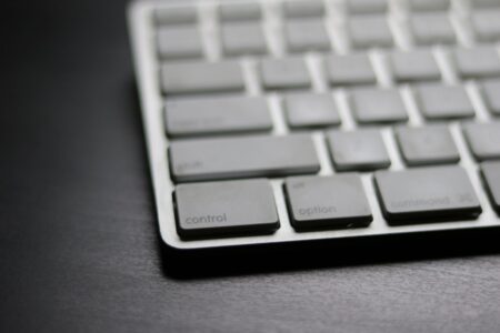 Raycast’s Productivity Layer Is Quietly Cornering Notion’s Power User Base A clean Mac desk setup with keyboard, representing keyboard-driven productivity tools