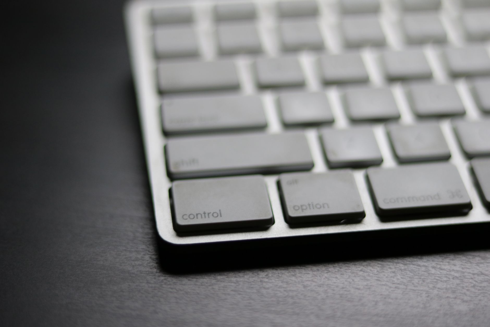 A clean Mac desk setup with keyboard, representing keyboard-driven productivity tools
