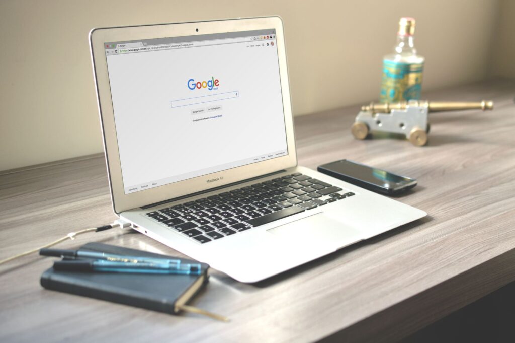 Employee searching for information on a laptop in a modern office environment