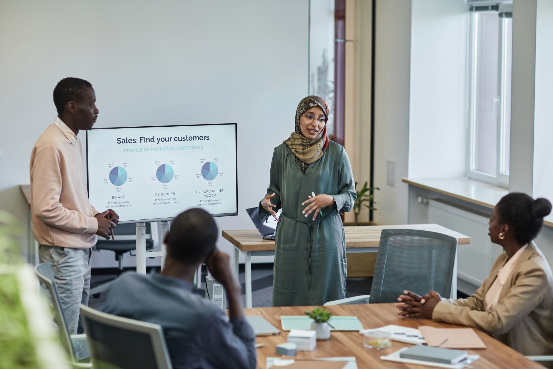 Sales team reviewing pitch materials in a modern office setting
