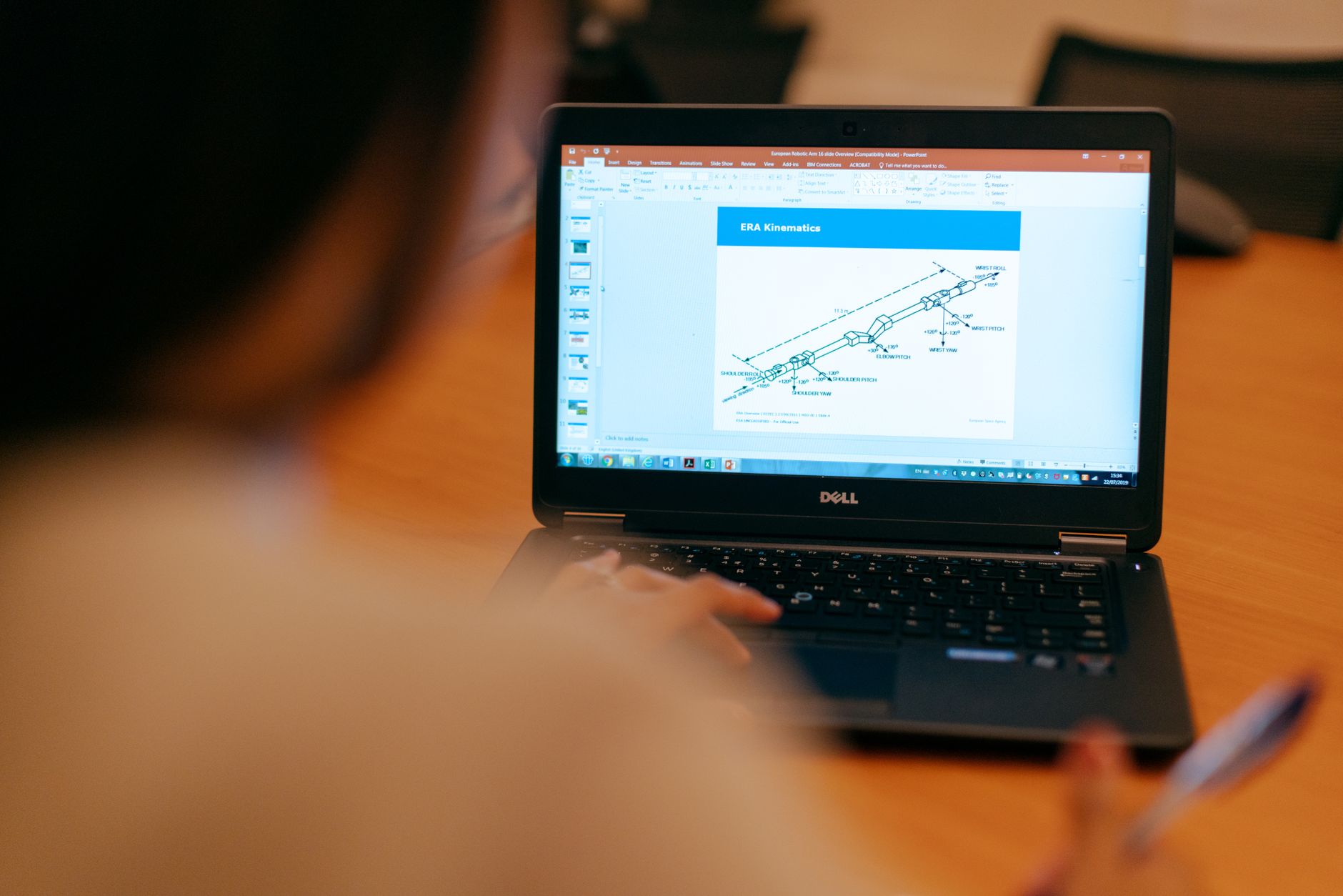 Person reviewing a digital project tracking interface on a laptop screen