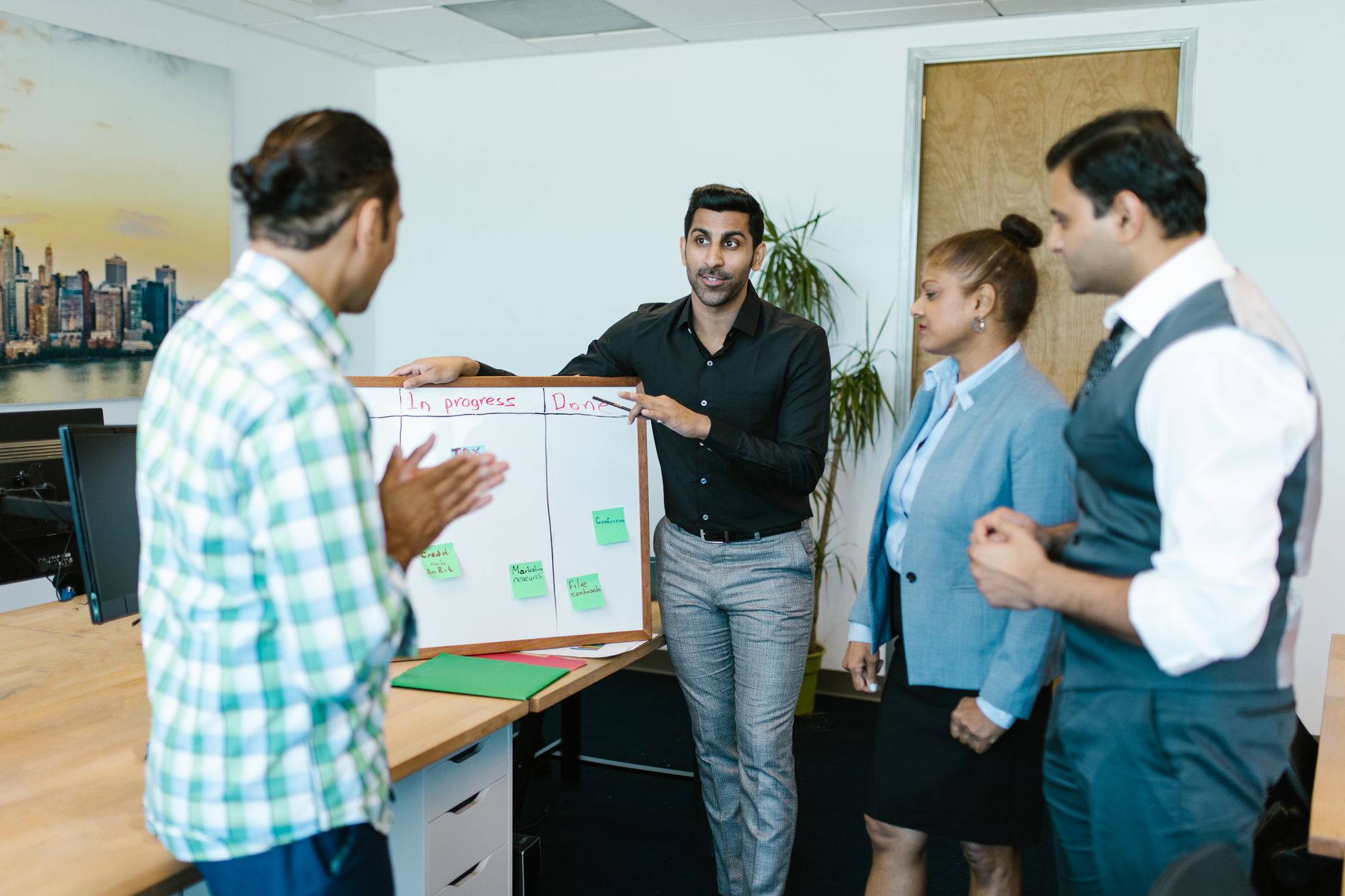 Small team gathered around a table in a modern office discussion
