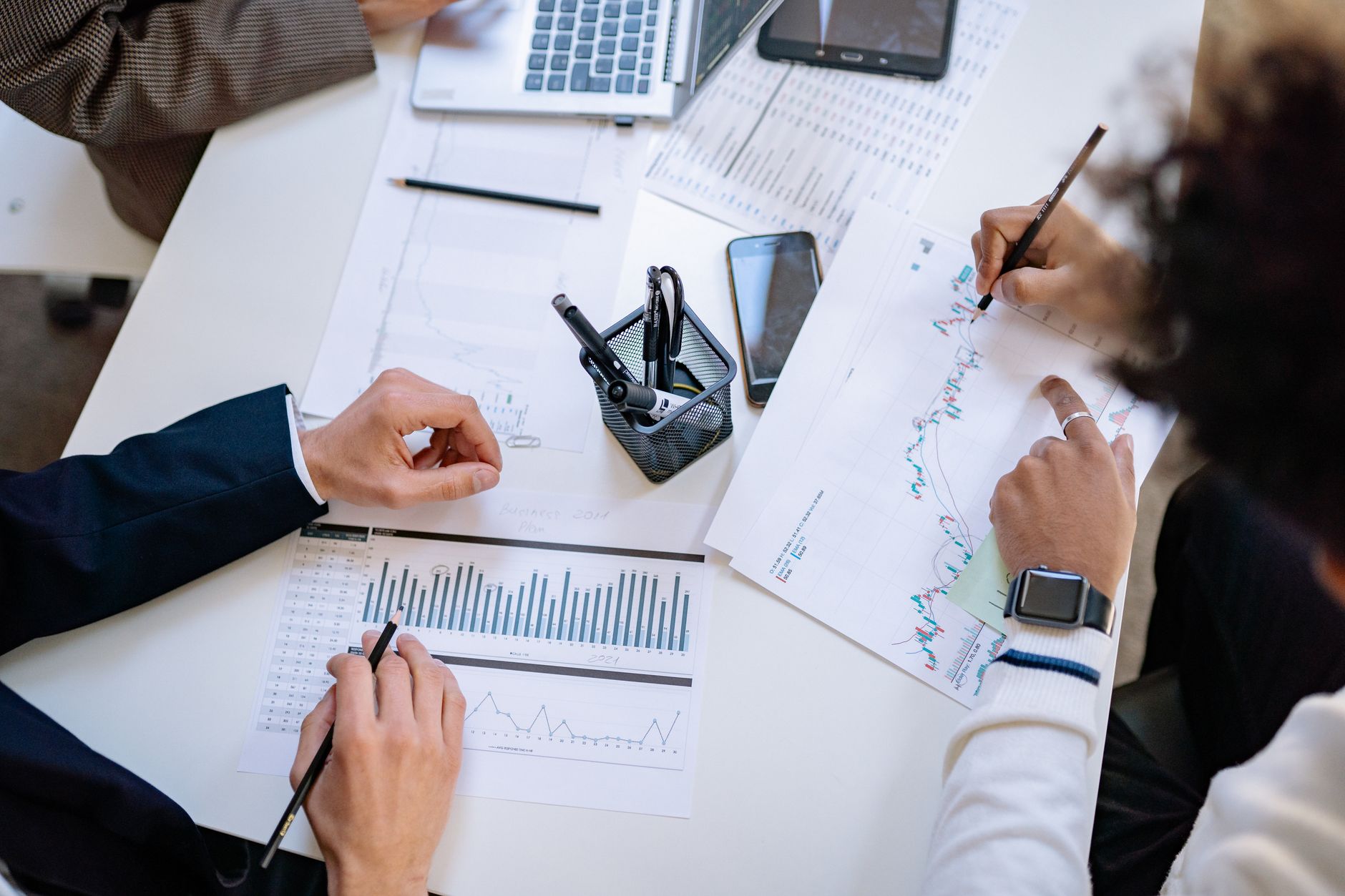 Business professionals reviewing analytics data and strategy documents in a meeting room