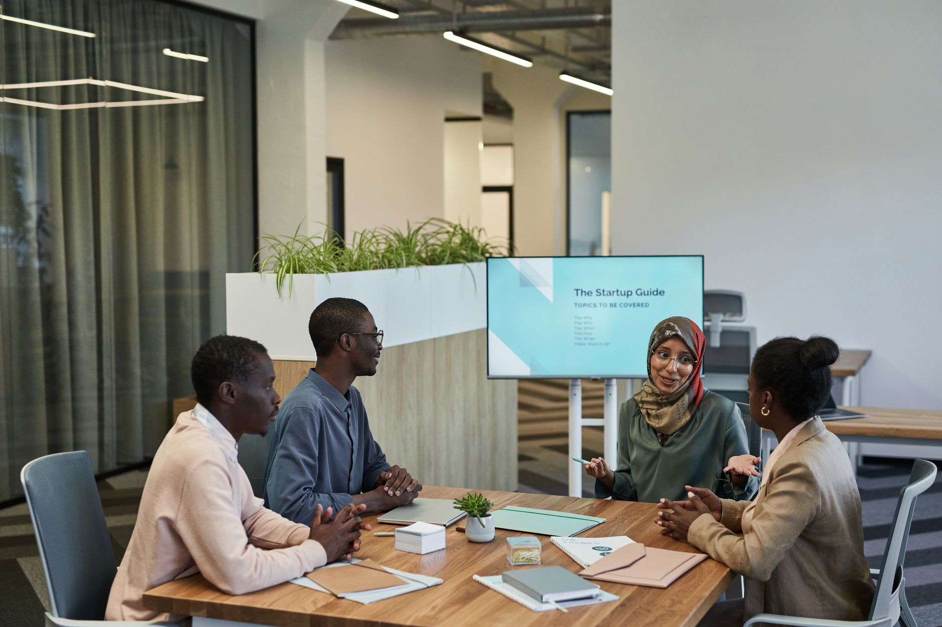 Startup team discussing strategy around a conference table