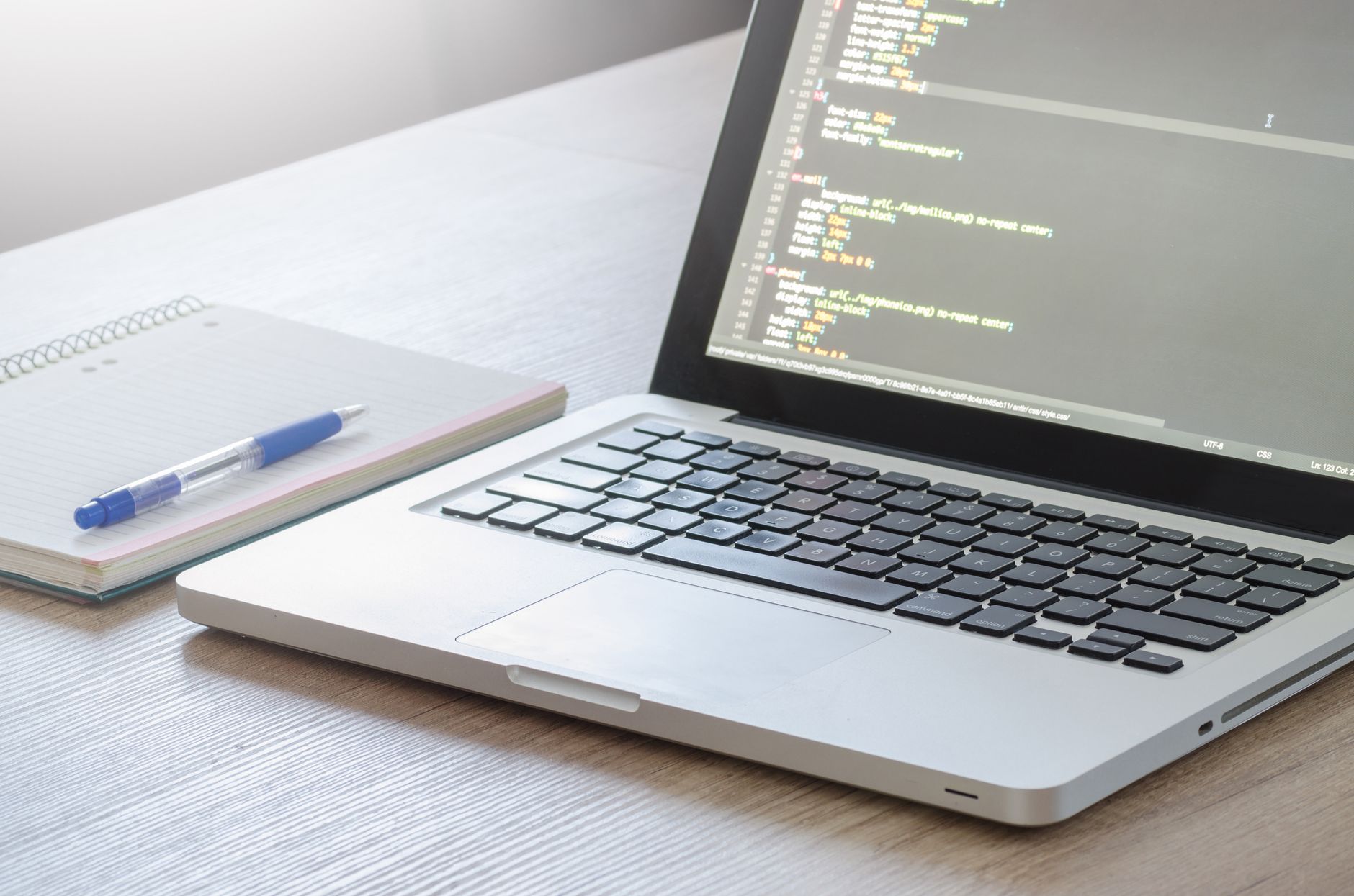 Designer reviewing a website layout on a monitor in a modern workspace