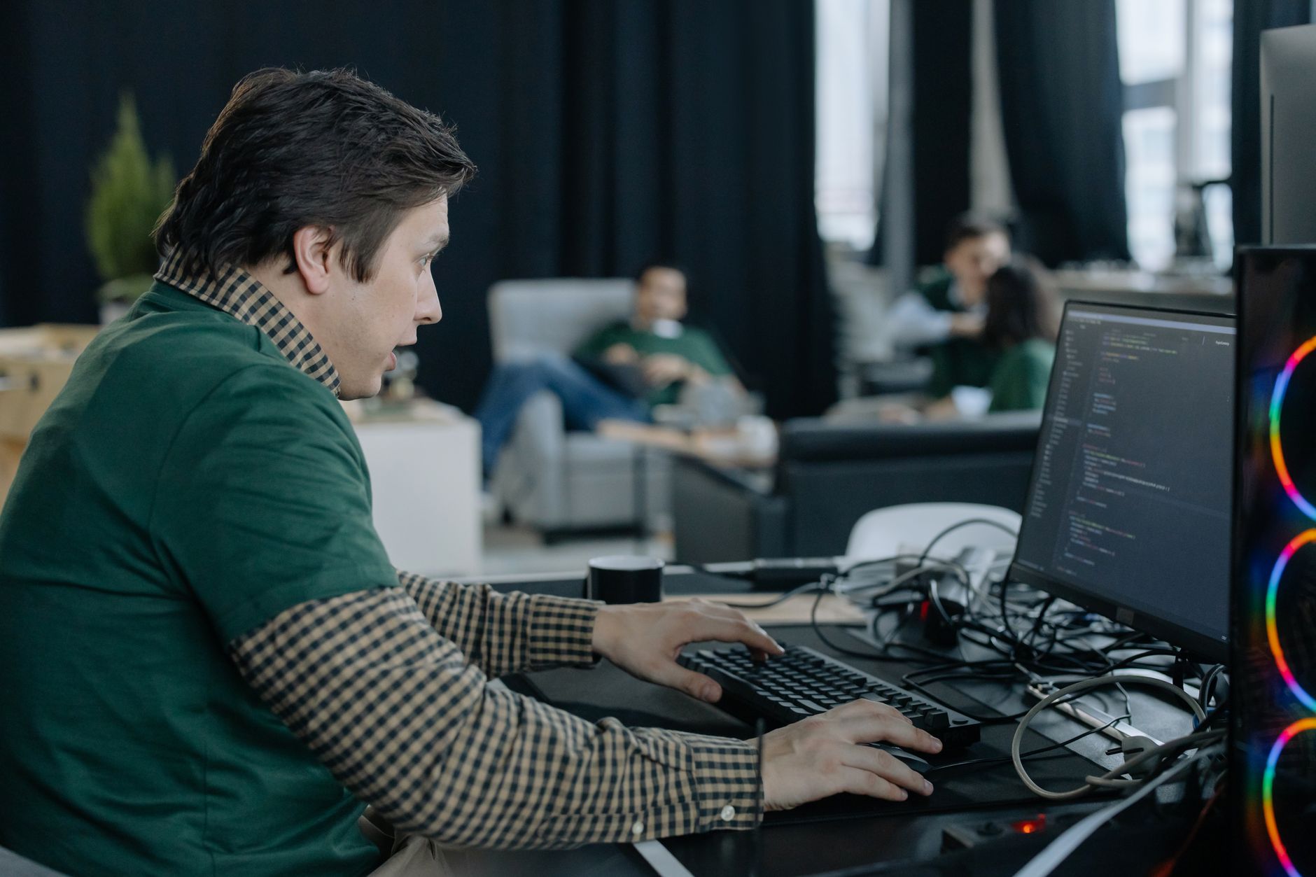 Modern technology startup workspace with developers at workstations
