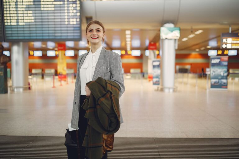 Navan’s Travel Management Push Is Quietly Cornering Expensify’s SMB Base Business traveler walking through a modern airport terminal with luggage