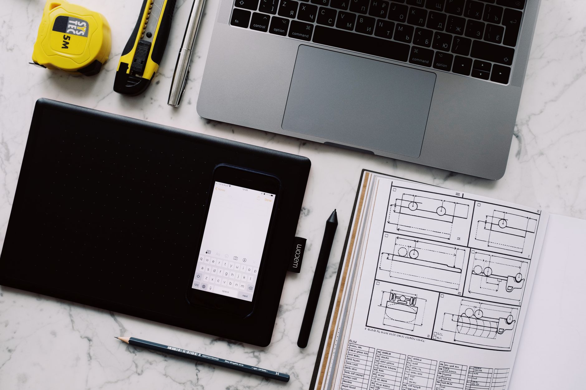 Freelance designer working on a website project at a laptop in a modern workspace