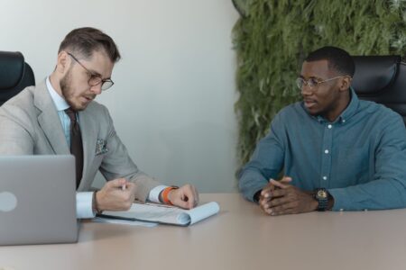 Mercor’s AI Hiring Layer Is Quietly Undercutting Deel’s Talent Base Two professionals conducting a job interview in a modern office setting