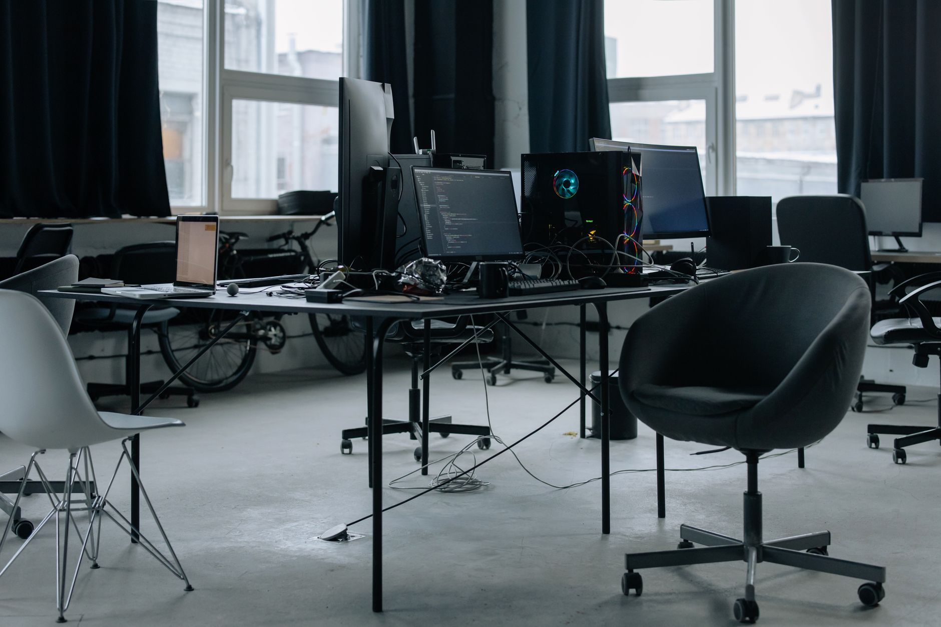A modern office setting showing a hiring process with a laptop and candidate profile on screen