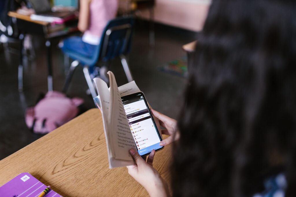Person using a smartphone app for language learning at a desk