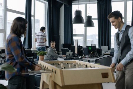 Attio’s CRM Flexibility Is Quietly Cornering HubSpot’s Startup Base A small startup team working together at desks in an open office environment