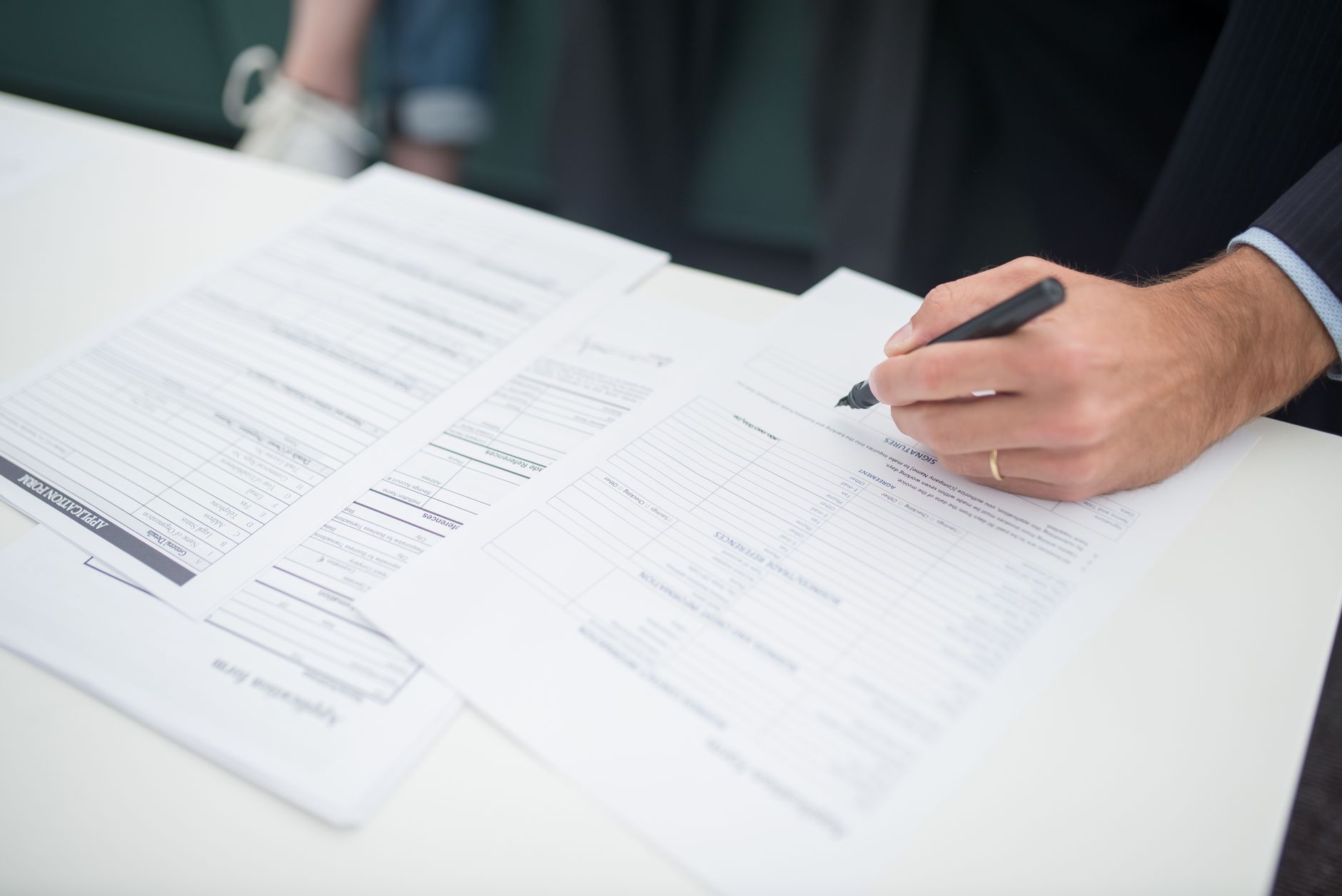 Person reviewing health insurance or benefits documents at a desk