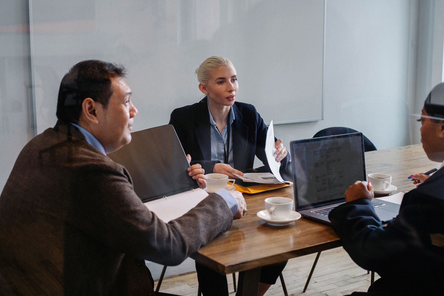 Two professionals reviewing documents and charts during a partnership meeting
