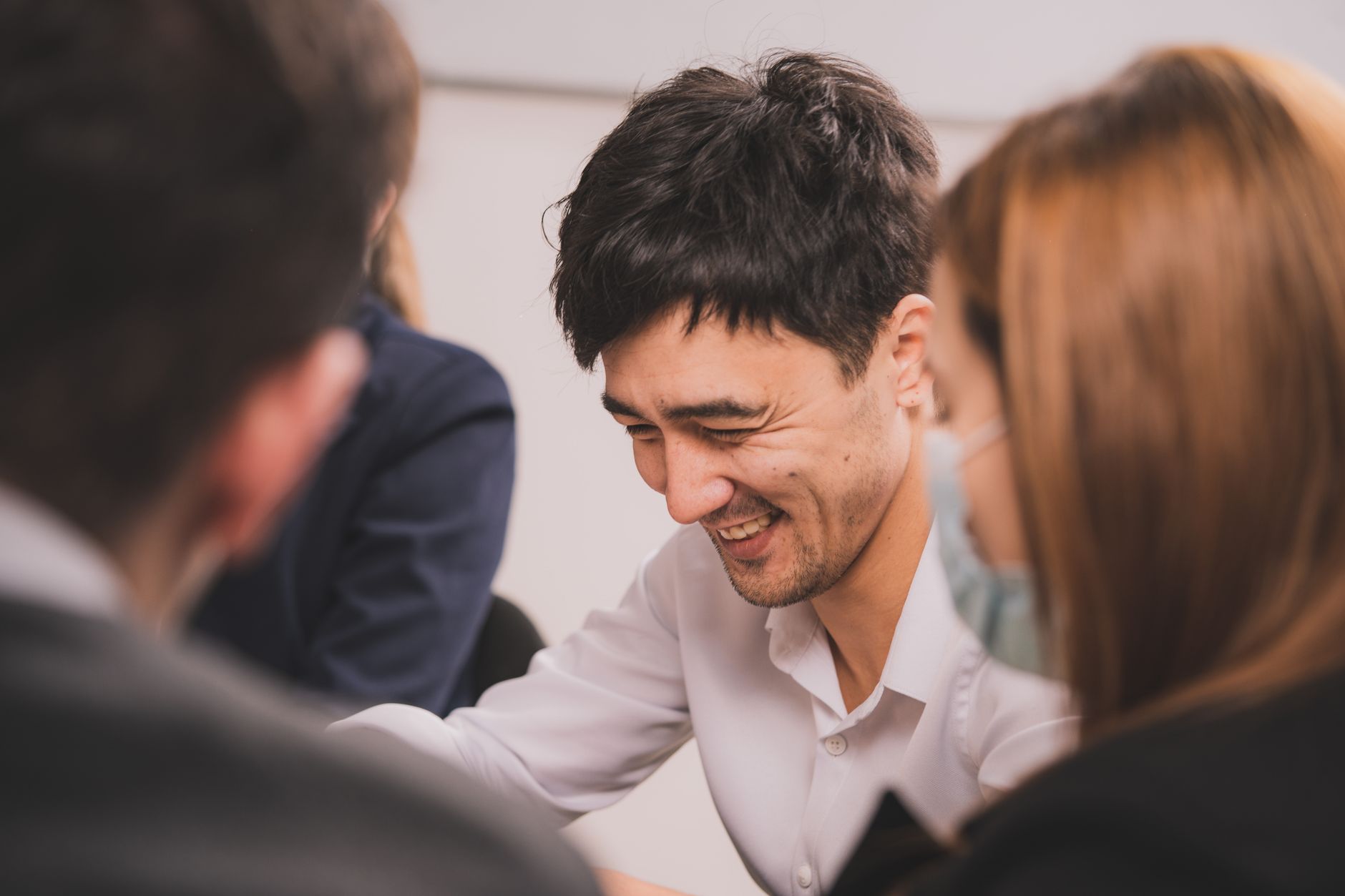 Small team of professionals collaborating around a conference table in an open office