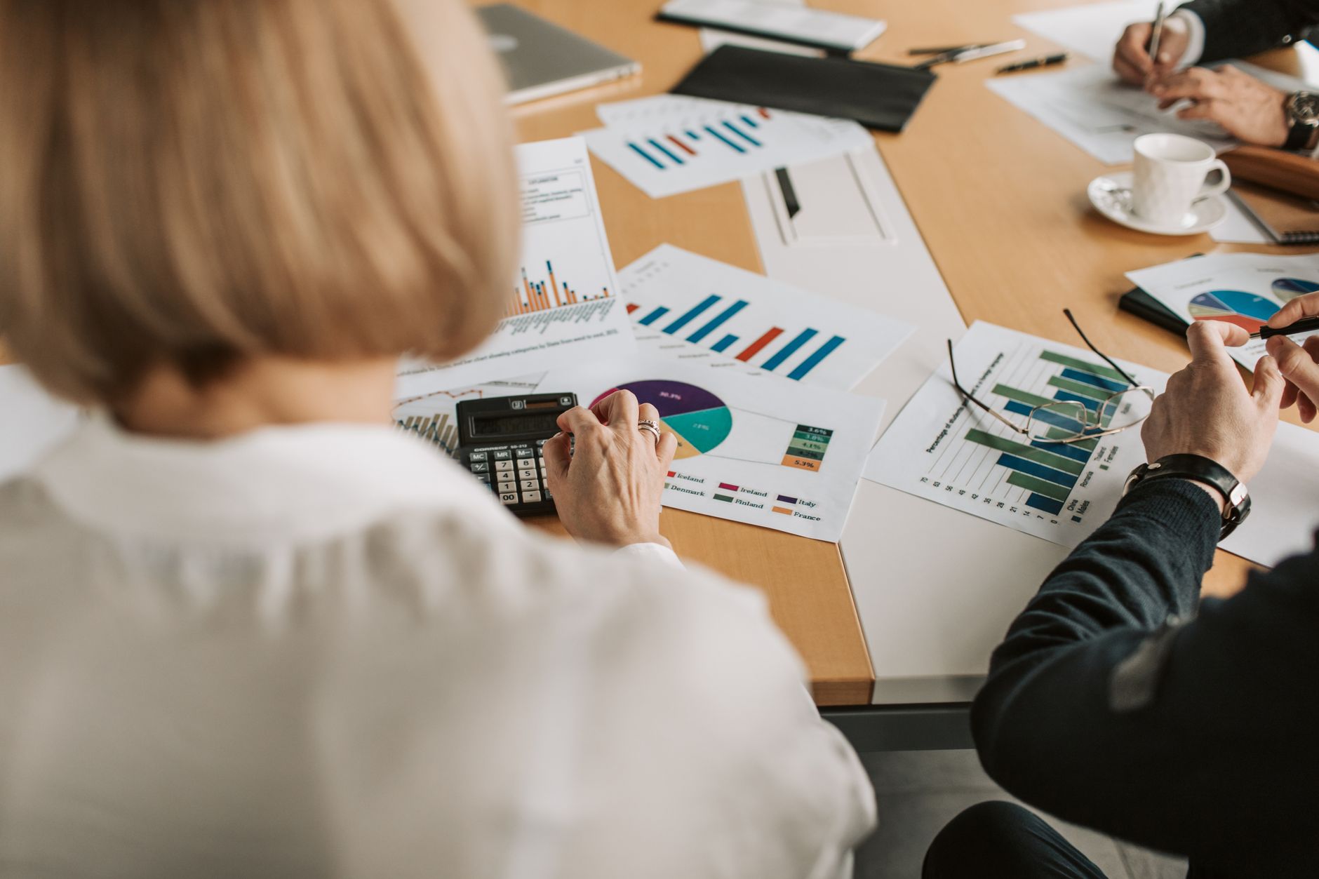 Hospital finance executives reviewing vendor contracts and revenue cycle data