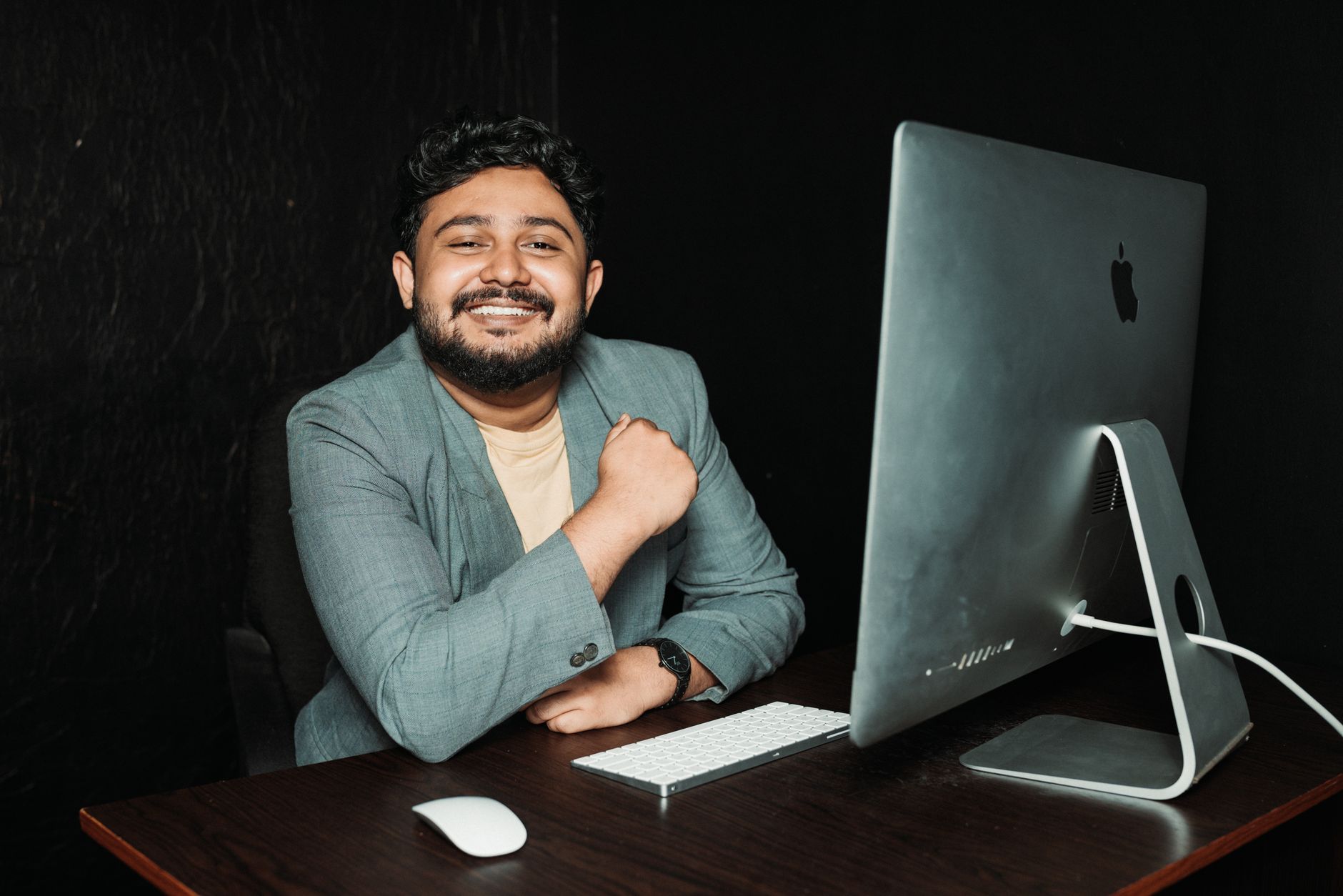 Entrepreneur at a desk reviewing software tools on a computer screen